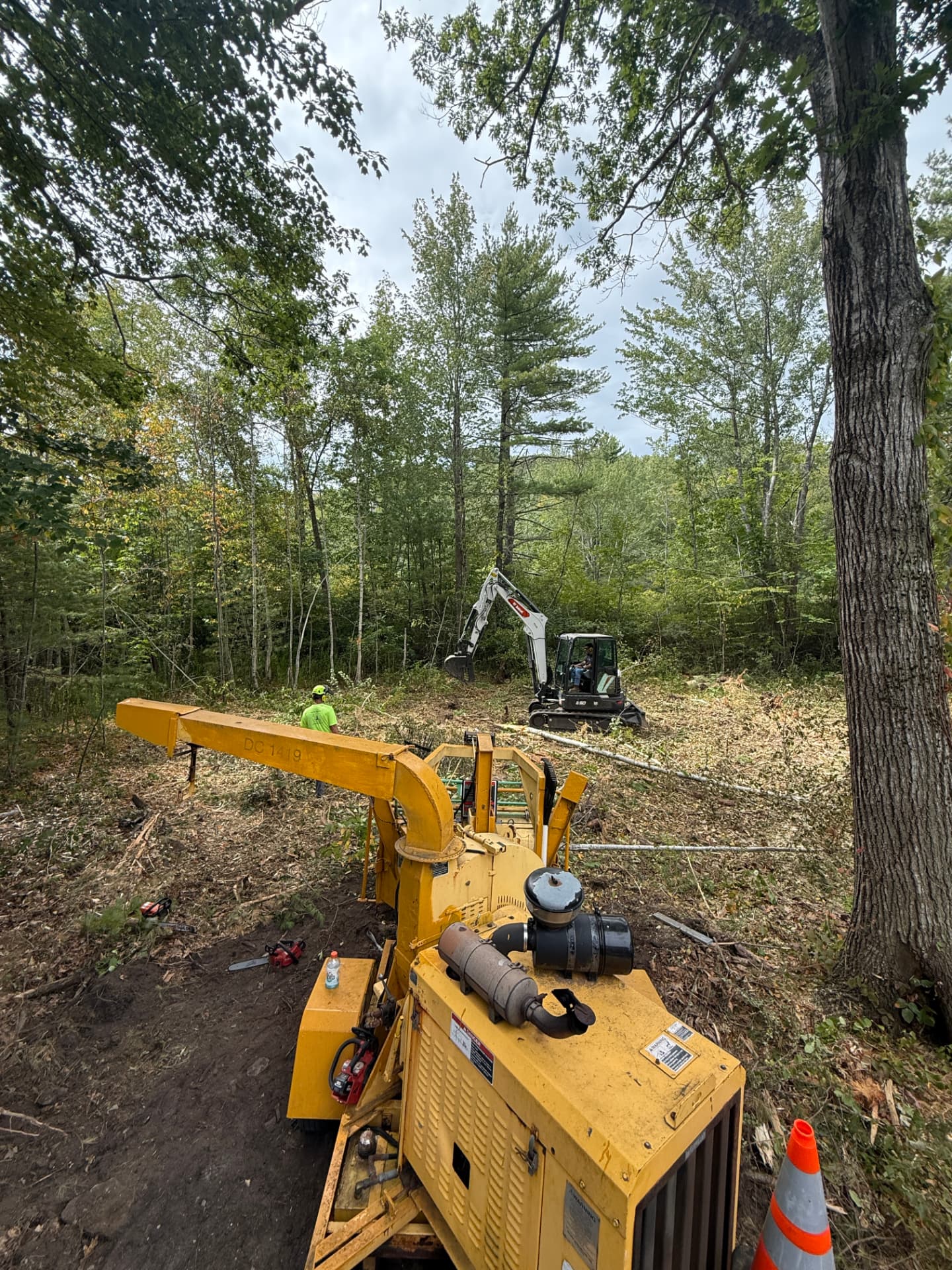 Skerry Timber crew clearing a New Hampshire lot with a chipper and excavator